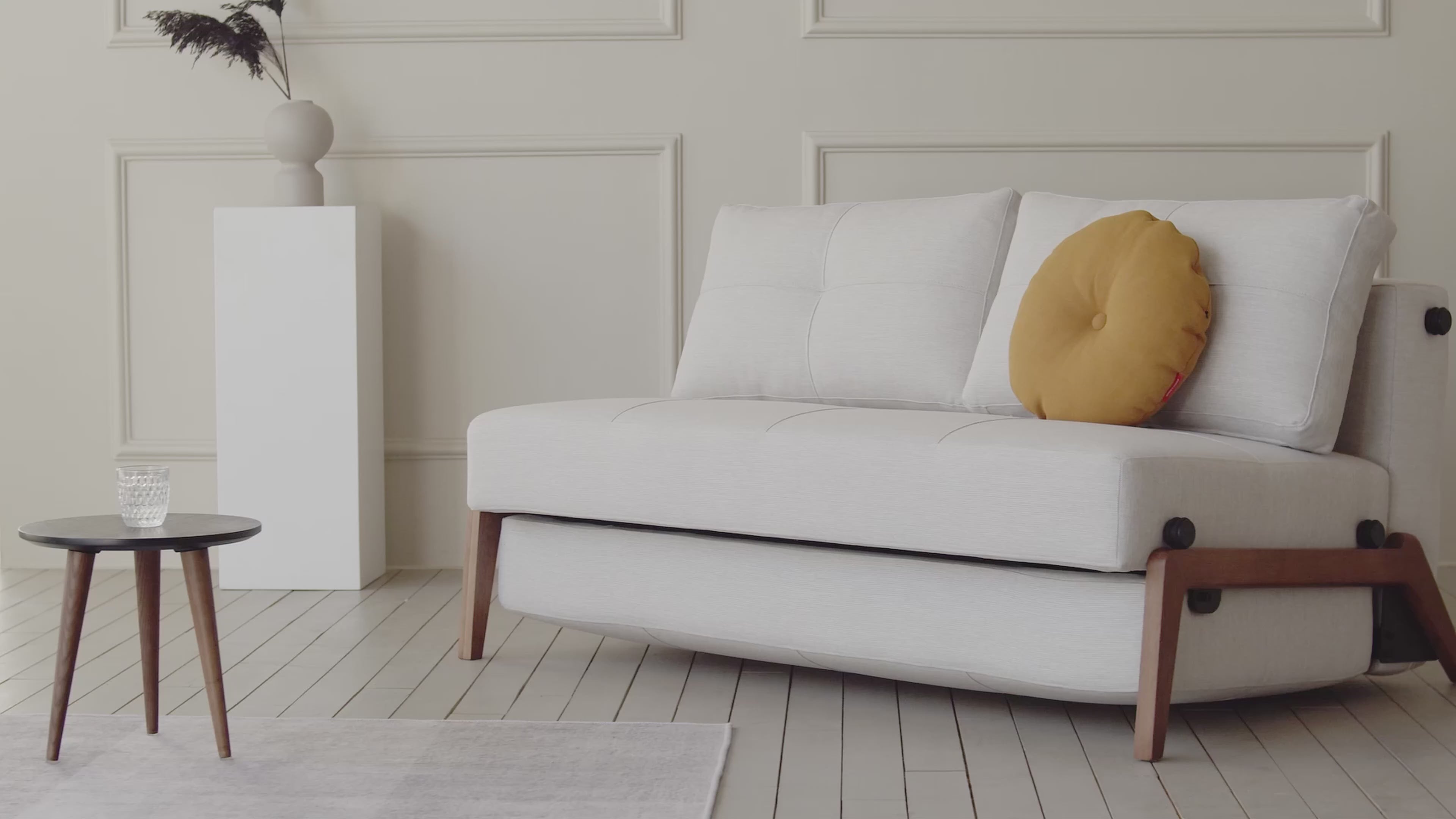Load video: Cubed Sofa Bed with Wood Legs